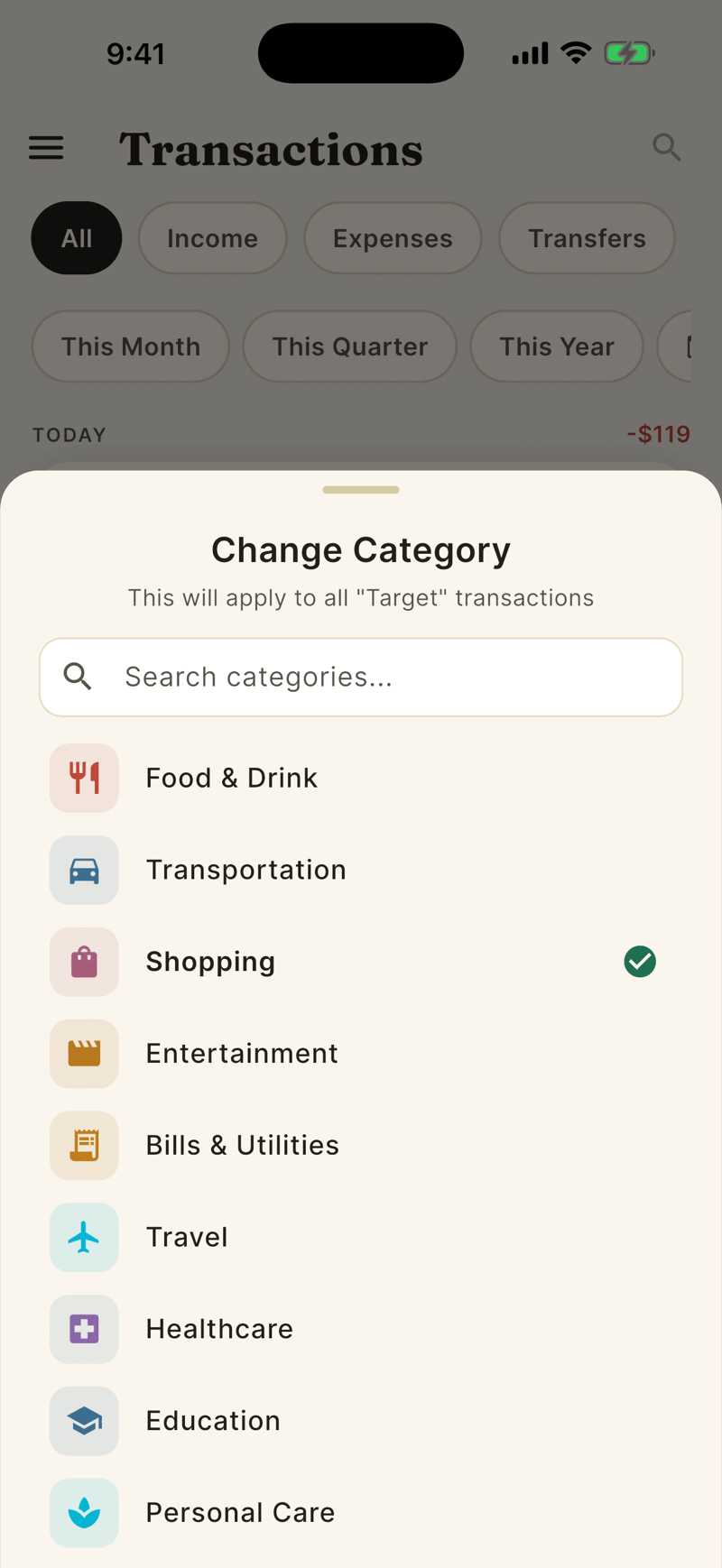 The Change Category sheet over the transaction list, naming the Target merchant, with a search box and a list of categories: Food and Drink, Transportation, Shopping with a green checkmark, Entertainment and more.